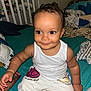 basketball, bed, bedroom, blanket, casual_clothing, child, crib, cute, face, hand, happy, indoors, miami_heat, person, sitting, skin, smiling, sweatpants, toddler, white_tank_top
