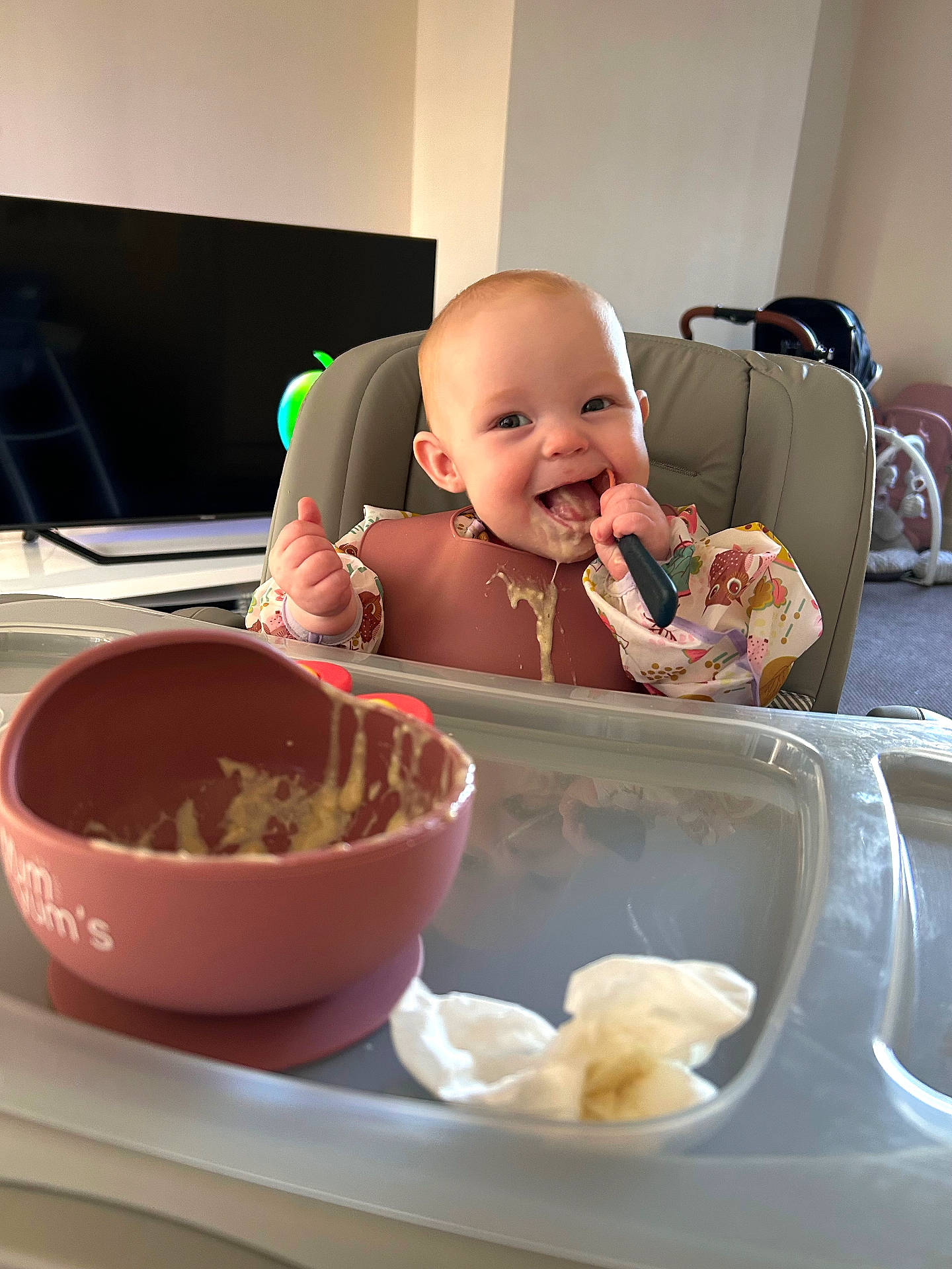 baby, bowl, clothing, computerhardware, cream, cutlery, dessert, eating, electronics, face, food, footwear, hardware, head, icecream, monitor, person, screen, shoe, spoon
