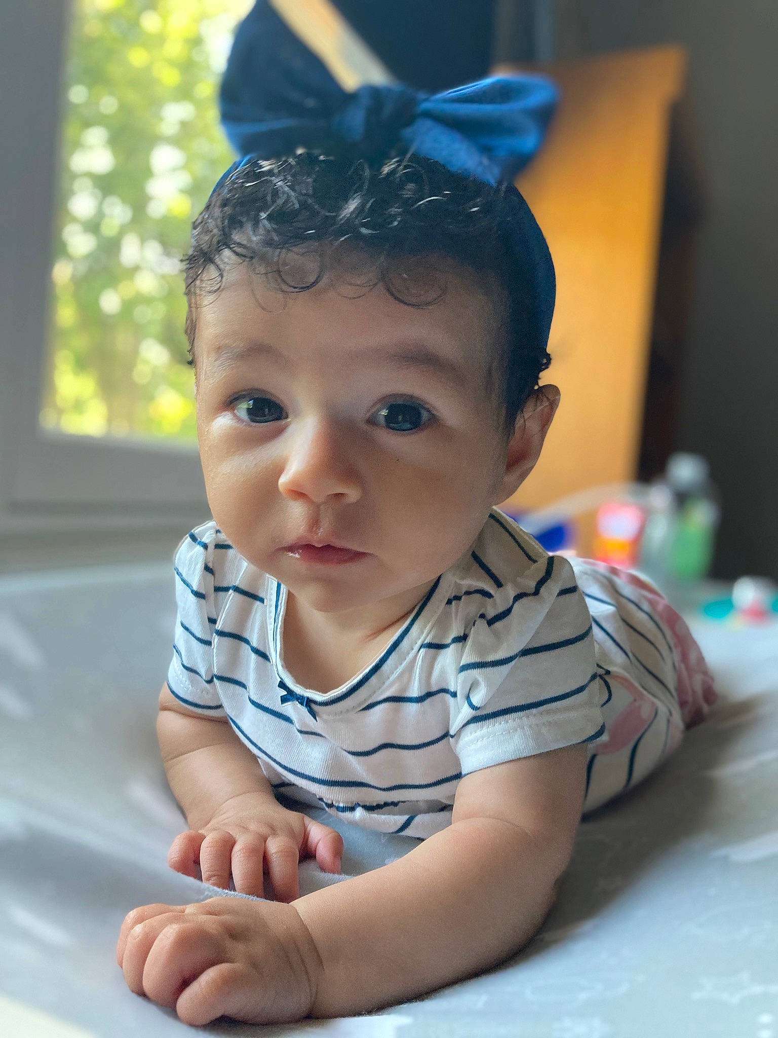 Amelia Rose joined the competition — help win amazing prizes! baby, baby_toddler_clothing, blue, cheek, child, finger, flooring, foot, fun, grass, hairstyle, happy, headgear, headpiece, human_body, iris, leisure, person, sitting, skin