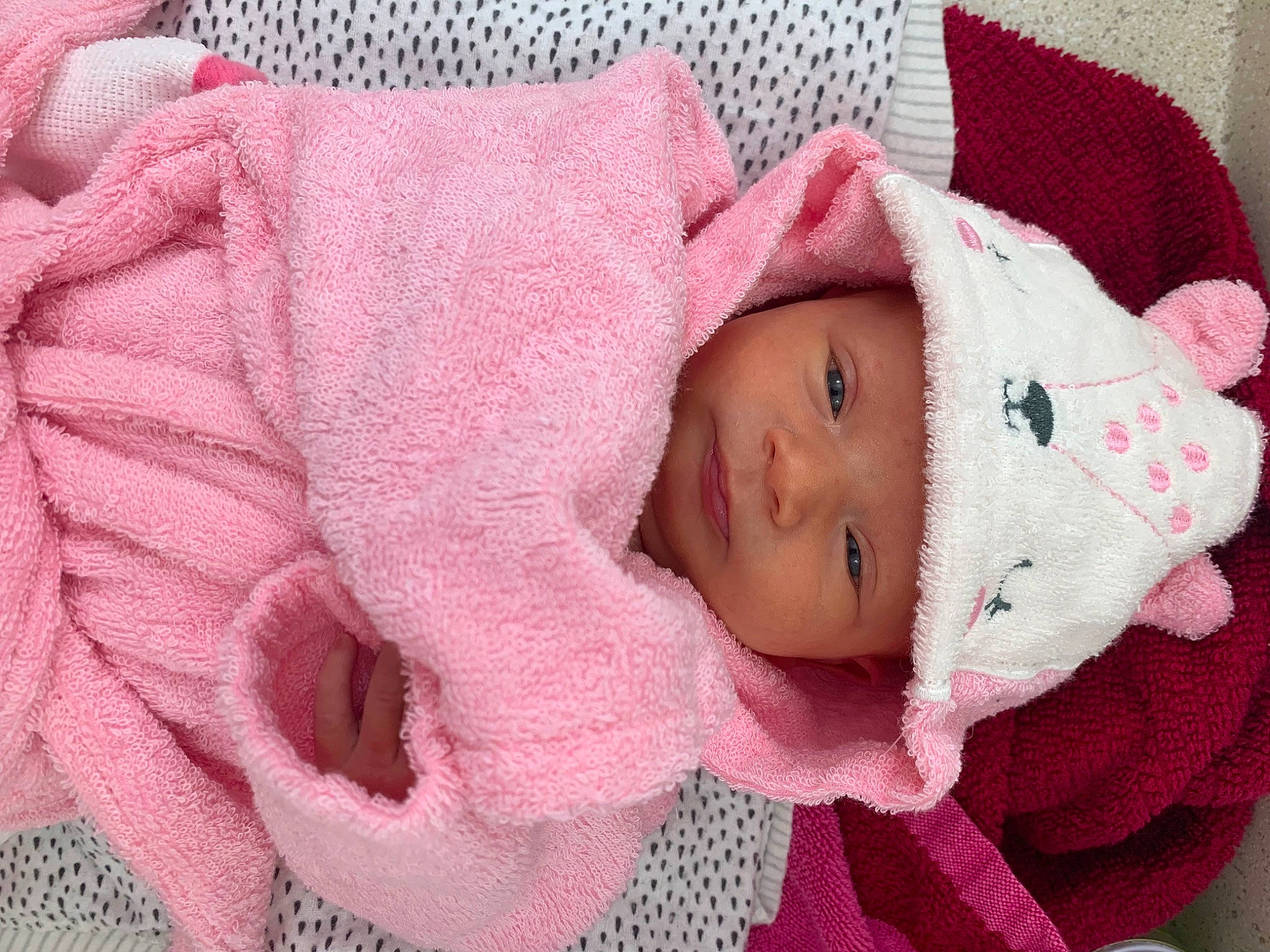 Nalani is registered to the contest to win money with this photo: baby, baby_toddler_clothing, cheek, clothing, comfort, eye, eyelash, hand, head, headgear, headwear, linens, lip, magenta, person, pink, product, skin, sleeve, textile