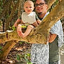 Edward Eible joined the competition — help win amazing prizes! baby, man, tree, forest, nature, outdoor, smiling, glasses, bib, branch, sand, leaves, sunlight, shadow, casual_clothing, holding, child, person, happy, playful