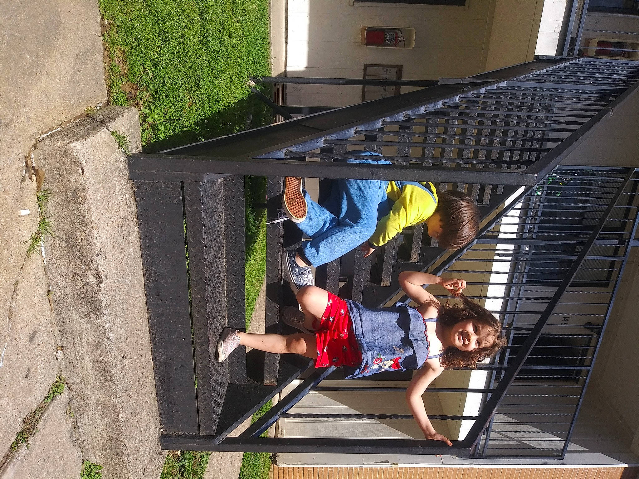 Davinity is registered to the contest to win money with this photo: building, composite_material, facade, fun, grass, handrail, house, joy, leisure, metal, person, plant, recreation, shorts, stairs, t_shirt, toddler, window