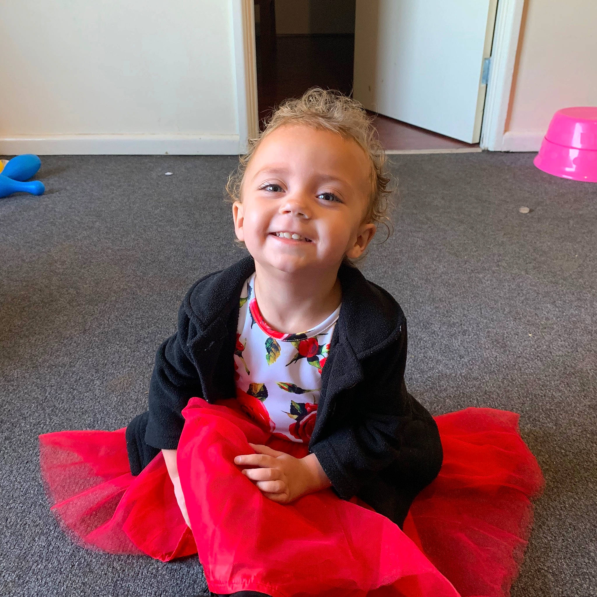 Kelsey is registered to the contest to win money with this photo: child, costume, floor, joy, outerwear, person, play, sitting, smile, toddler