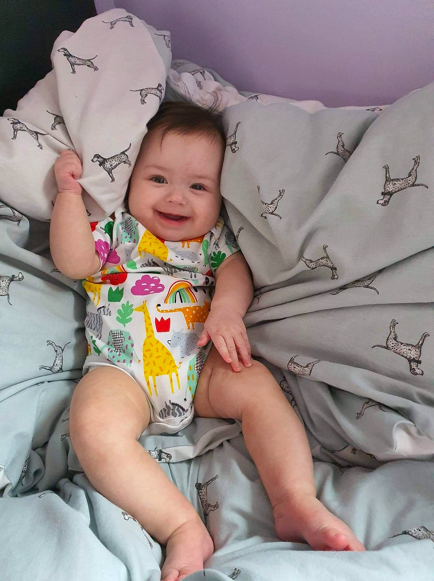 Angelina is registered to the contest to win money with this photo: arm, baby, baby_toddler_clothing, comfort, facial_expression, finger, happy, human_body, joy, knee, lap, leg, mouth, muscle, person, product, skin, smile, t_shirt, textile