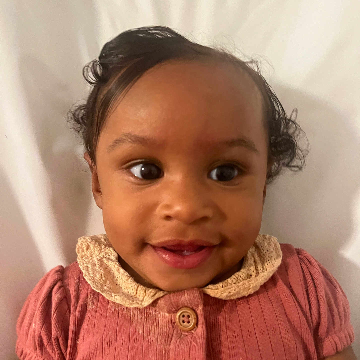 Teya is registered to the contest to win money with this photo: baby, background, button, child, closeup, clothing, cute, eyes, face, hair, happy, head, infant, lace, person, pink, portrait, skin, smile, young