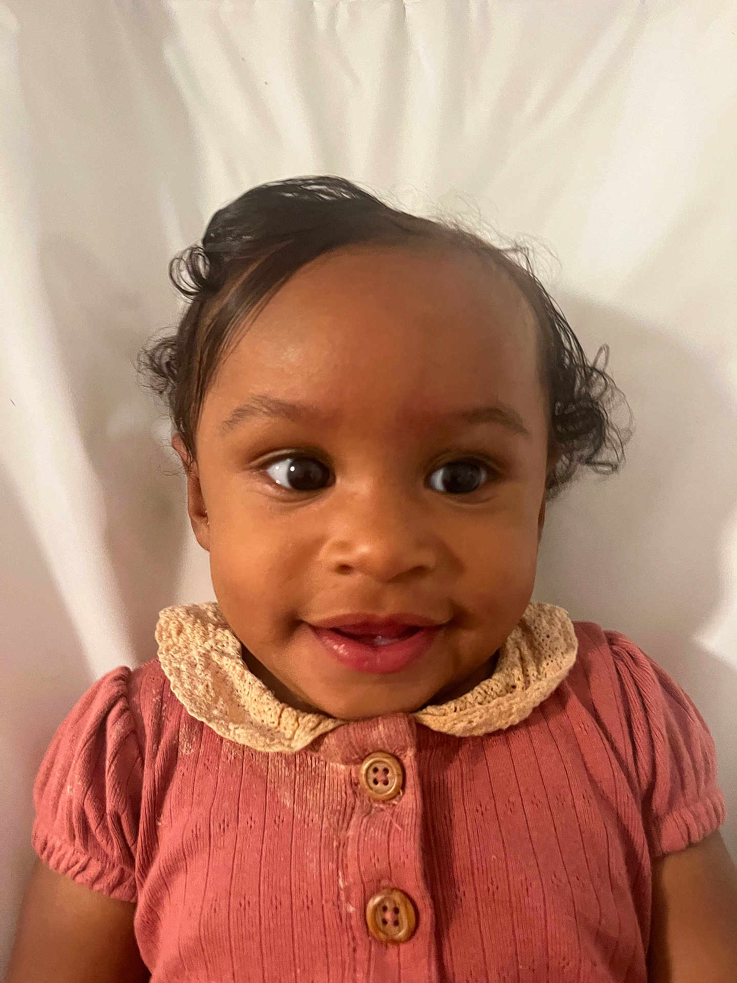 Teya is registered to the contest to win money with this photo: baby, child, smile, face, eyes, clothing, pink, button, lace, head, hair, portrait, cute, happy, infant, person, skin, background, closeup, young