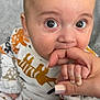 baby, infant, hand, finger, cute, wide_eyes, animal_print, clothing, grip, close_up, indoors, cozy, texture, skin, nail, person, child, sitting, cute_expression, holding
