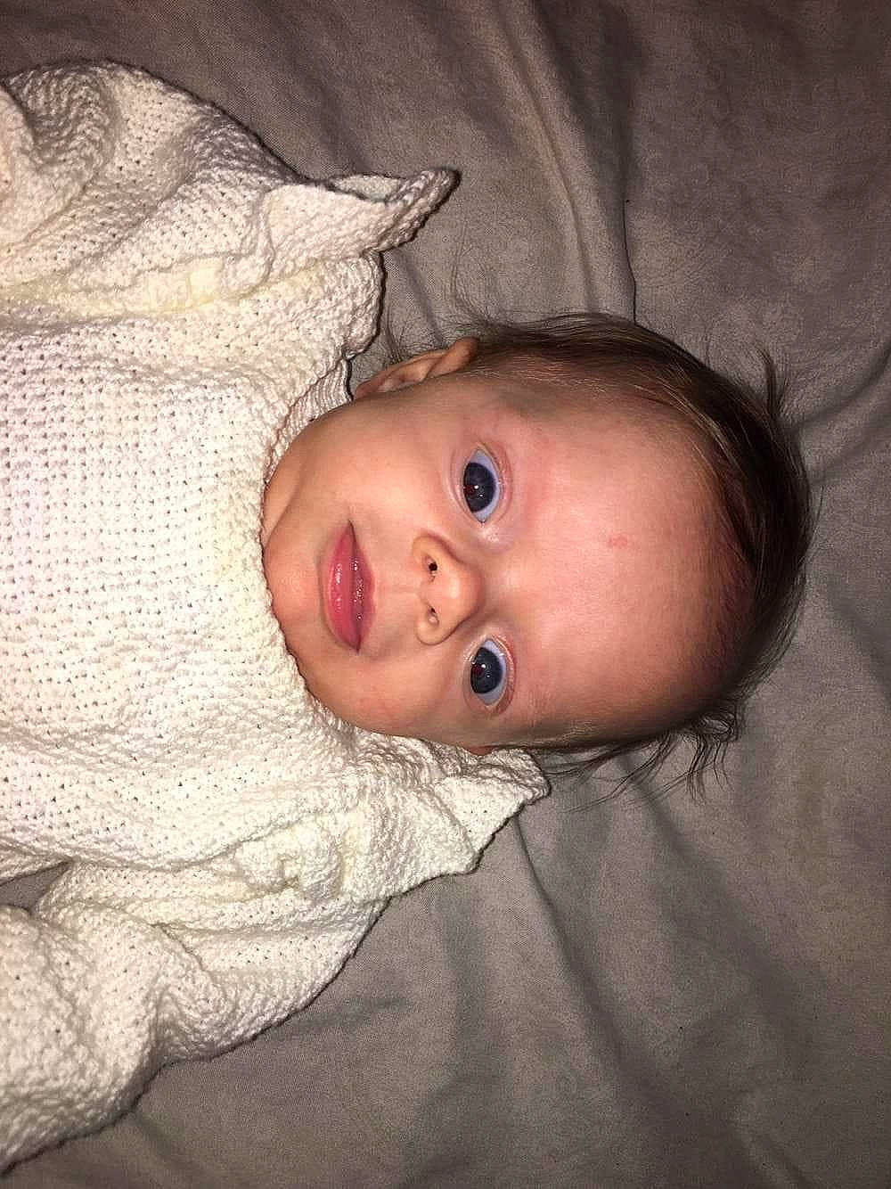 Kinsley joined the competition — help win amazing prizes! baby, baby_toddler_clothing, cheek, child, comfort, eyelash, flash_photography, flesh, fur, hair, linens, lip, nose, outerwear, person, portrait_photography, skin, sleeve, smile, toddler