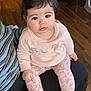 Brianna joined the competition — help win amazing prizes! baby, infant, child, sitting, sweater, floral_leggings, pink_socks, lap, caretaker, face, eyes, dark_hair, hardwood_floor, chair, indoor, portrait, cute, rosy_cheeks, casual_clothing, hands