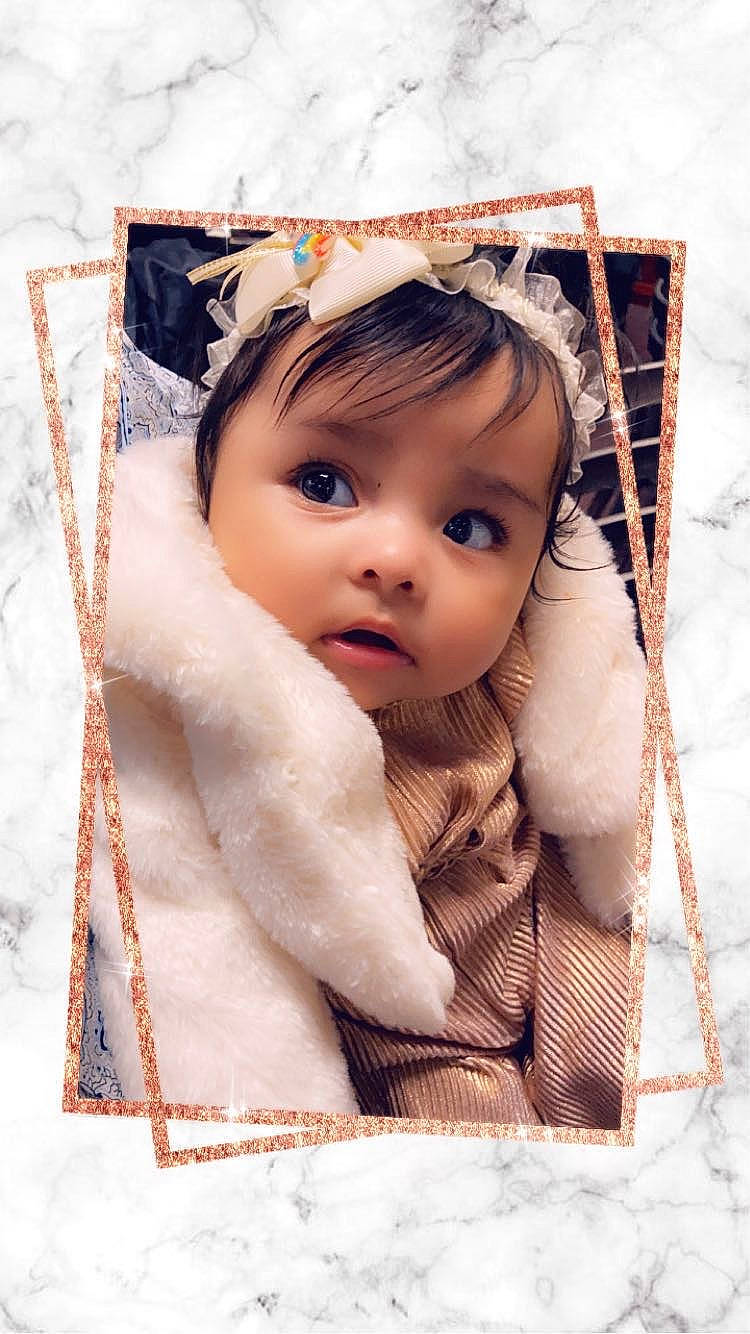 Aryana is registered to the contest to win money with this photo: baby, cheek, child, chin, eyelash, fashion_accessory, flash_photography, happy, headgear, iris, linens, lip, people_in_nature, person, skin, stock_photography, textile, toddler, window, winter