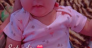 Victoria is registered to the contest to win money with this photo: baby, infant, child, portrait, sitting, pink_bow, headband, onesie, blanket, bed, indoor, bedroom, furniture, face, eyes, serious_expression, cozy, timestamp, text_overlay, photograph