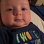 Wesson is registered to the contest to win money with this photo: baby, close_up, face, chubby_cheeks, shirt, colorful_text, indoor, bed, blanket, video_call, infant, child, young, portrait, cute, expressionless, clothing, person, human, casual