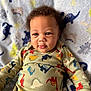 Saint joined the competition — help win amazing prizes! baby, child, dinosaur, onesie, blanket, pattern, cute, smile, face, portrait, indoor, soft, curly_hair, infant, colorful, cozy, clothing, happy, young, toddler