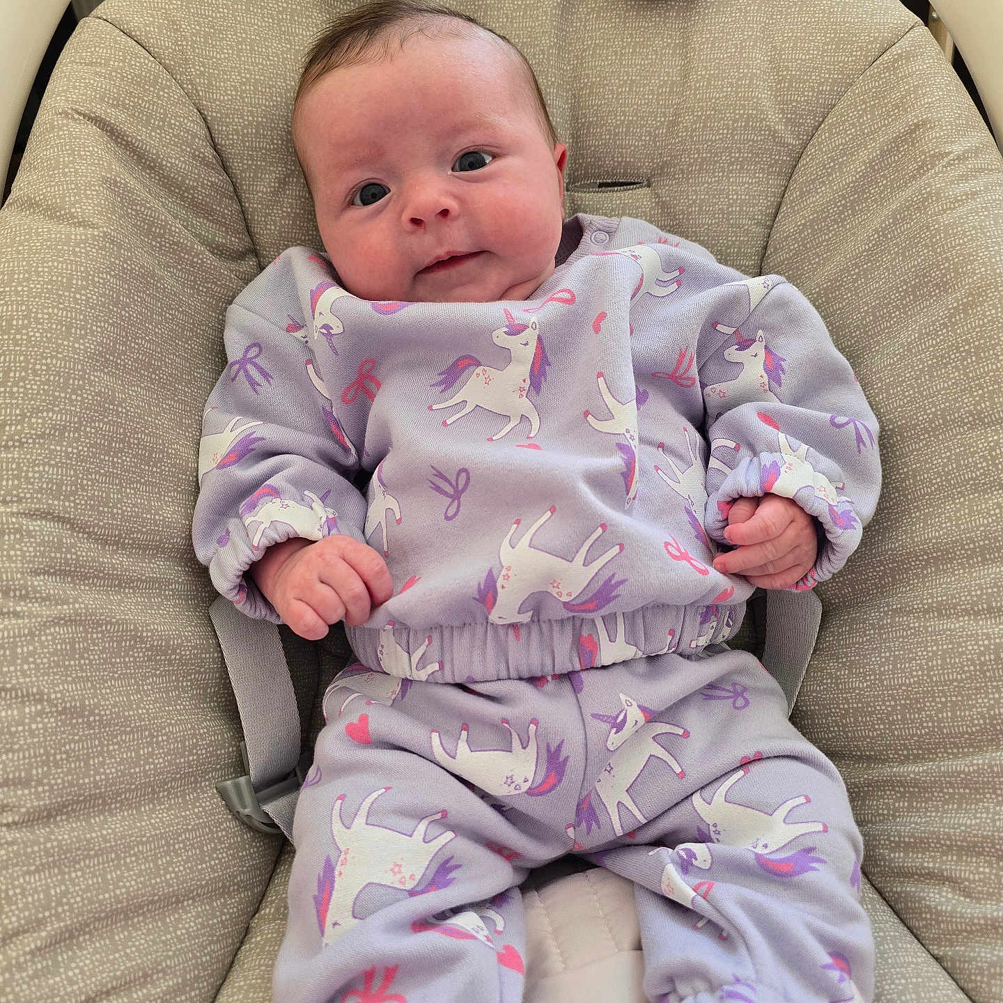 Arella joined the competition — help win amazing prizes! baby, baby_chair, baby_wear, child, comfort, cushion, cute, footwear, indoors, infant, lavender_clothing, person, portrait, relaxation, seated, small_hands, smile, soft_fabric, unicorn_pattern, wide_eyes