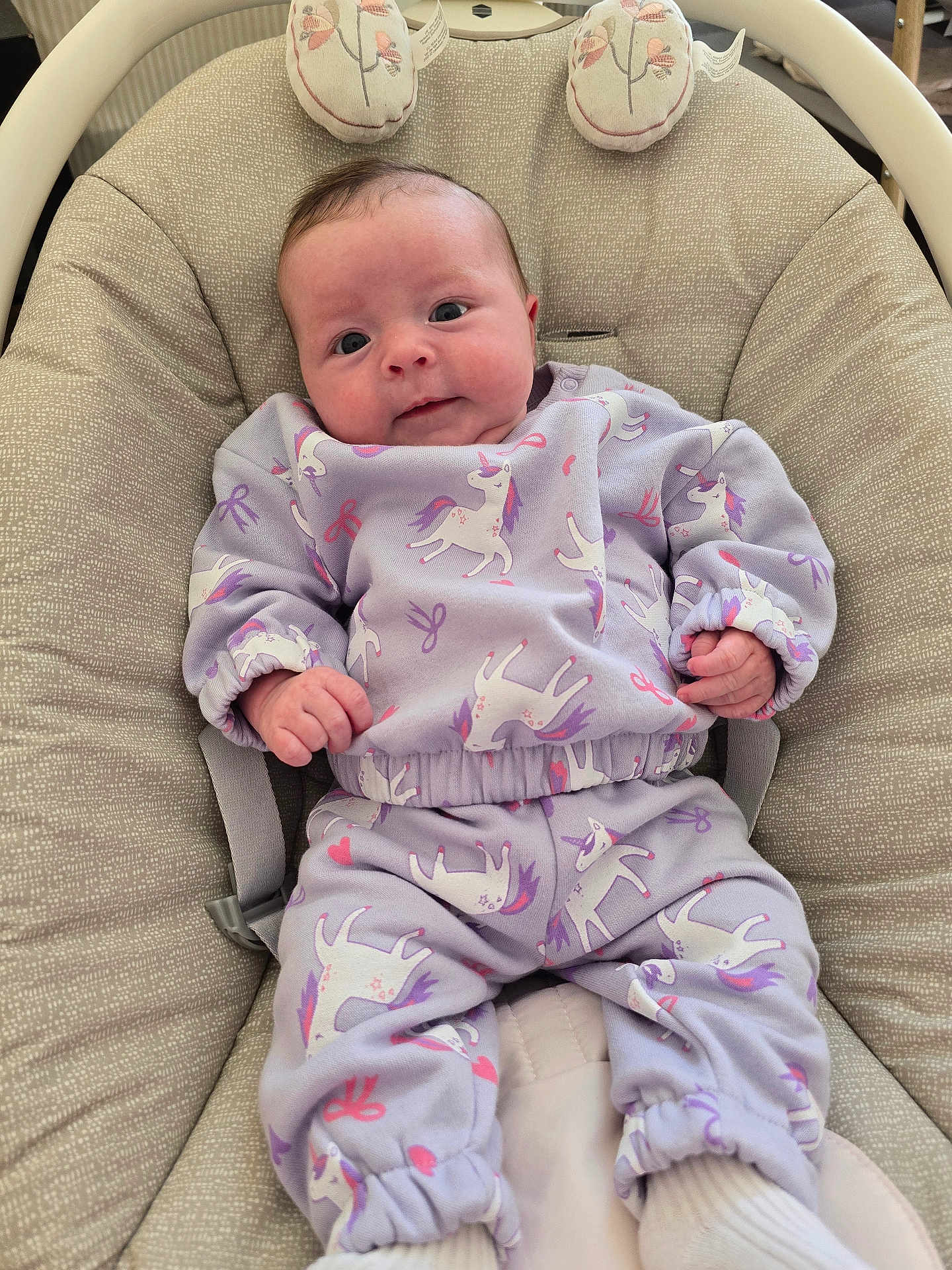 Arella joined the competition — help win amazing prizes! baby, infant, unicorn_pattern, lavender_clothing, baby_chair, cushion, seated, cute, portrait, indoors, child, person, smile, wide_eyes, soft_fabric, comfort, small_hands, footwear, baby_wear, relaxation