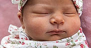 Gabriella joined the competition — help win amazing prizes! newborn, baby, sleeping, swaddle, headband, floral_pattern, pink_blanket, infant, cute, peaceful, face, portrait, child, soft_texture, closeup, wrapped, adorable, resting, young, lying_down