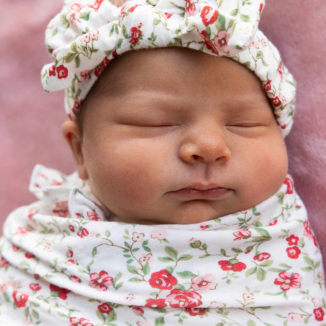 Gabriella joined the competition — help win amazing prizes! newborn, baby, sleeping, swaddle, headband, floral_pattern, pink_blanket, infant, cute, peaceful, face, portrait, child, soft_texture, closeup, wrapped, adorable, resting, young, lying_down