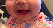 Gabriella joined the competition — help win amazing prizes! baby, child, clothing, colorful, cute, eyes, face, hand, happy, holding, human, indoor, infant, mouth, onesie, pattern, person, portrait, skin, smiling
