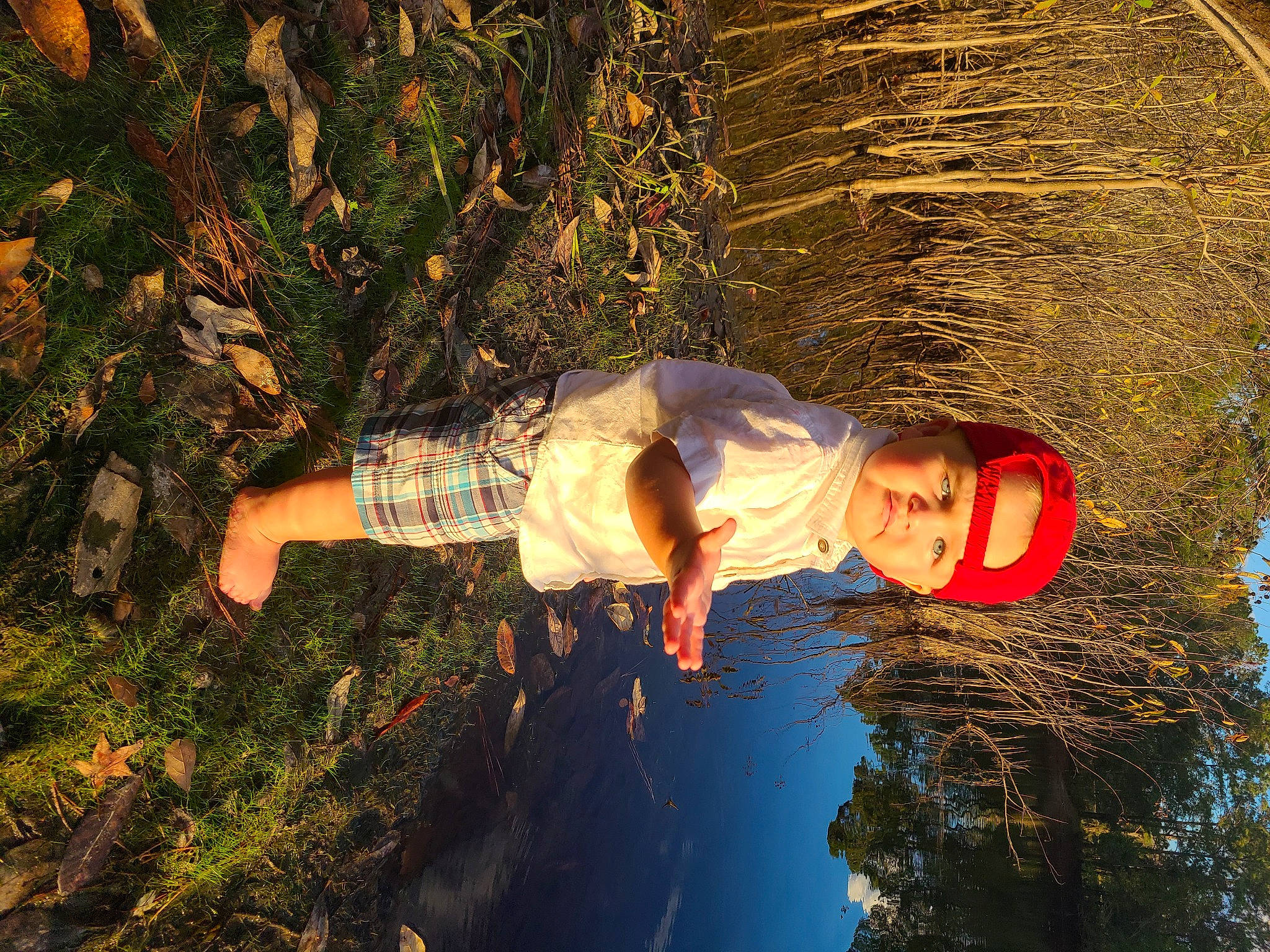 Jaxson is registered to the contest to win money with this photo: headwear, people_in_nature, person, plant, reflection, tree, water