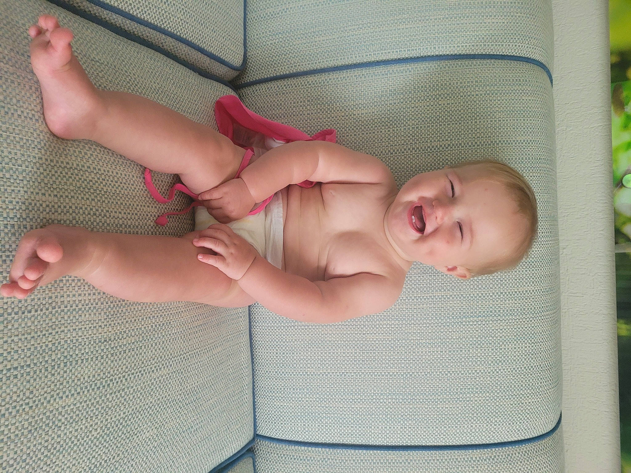 Victoria is registered to the contest to win money with this photo: arm, baby, baby_safety, chest, child, comfort, eye, face, finger, head, human_body, infant_bed, knee, leg, person, skin, smile, textile, thigh, thumb