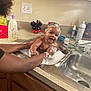 baby, bath, sink, bubbles, foam, soap, kitchen, child, person, arms, water, cleaning, smile, happy, head, cabinet, countertop, bottle, mickey_mouse, playful