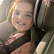 Arya is registered to the contest to win money with this photo: child, car_seat, smile, sunlight, seatbelt, happy, toddler, hair, clothing, interior, car, face, safety, seat, cute, young_child, daylight, portrait, person, window