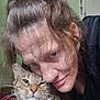 affection, animal, bond, cat, close_up, domestic, expression, face, friendship, fur, hair, human, indoor, person, pet, portrait, smile, tabby_cat, whiskers, woman