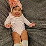 Harper joined the competition — help win amazing prizes! baby, infant, smiling, tongue_out, headwrap, bow, onesie, knee_high_socks, chubby_legs, blanket, cozy, portrait, indoor, adorable, cute, dark_hair, rosy_cheeks, sitting, happy, soft_texture