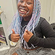 Amari is registered to the contest to win money with this photo: black_clothing, braided_hair, cabinet, carpet, child, colorful_hair, cream_on_face, door, expression, fan, fun, furniture, happy, indoor, person, sitting, skirt, smiling, thumbs_up, young