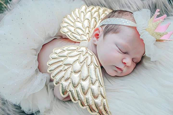 Piper is registered to the contest to win money with this photo: angel, baby, bonnet, child, ear, fashion_accessory, feather, fictional_character, fur, hair_accessory, headband, headgear, headpiece, person, pink, sleep, toddler, wing