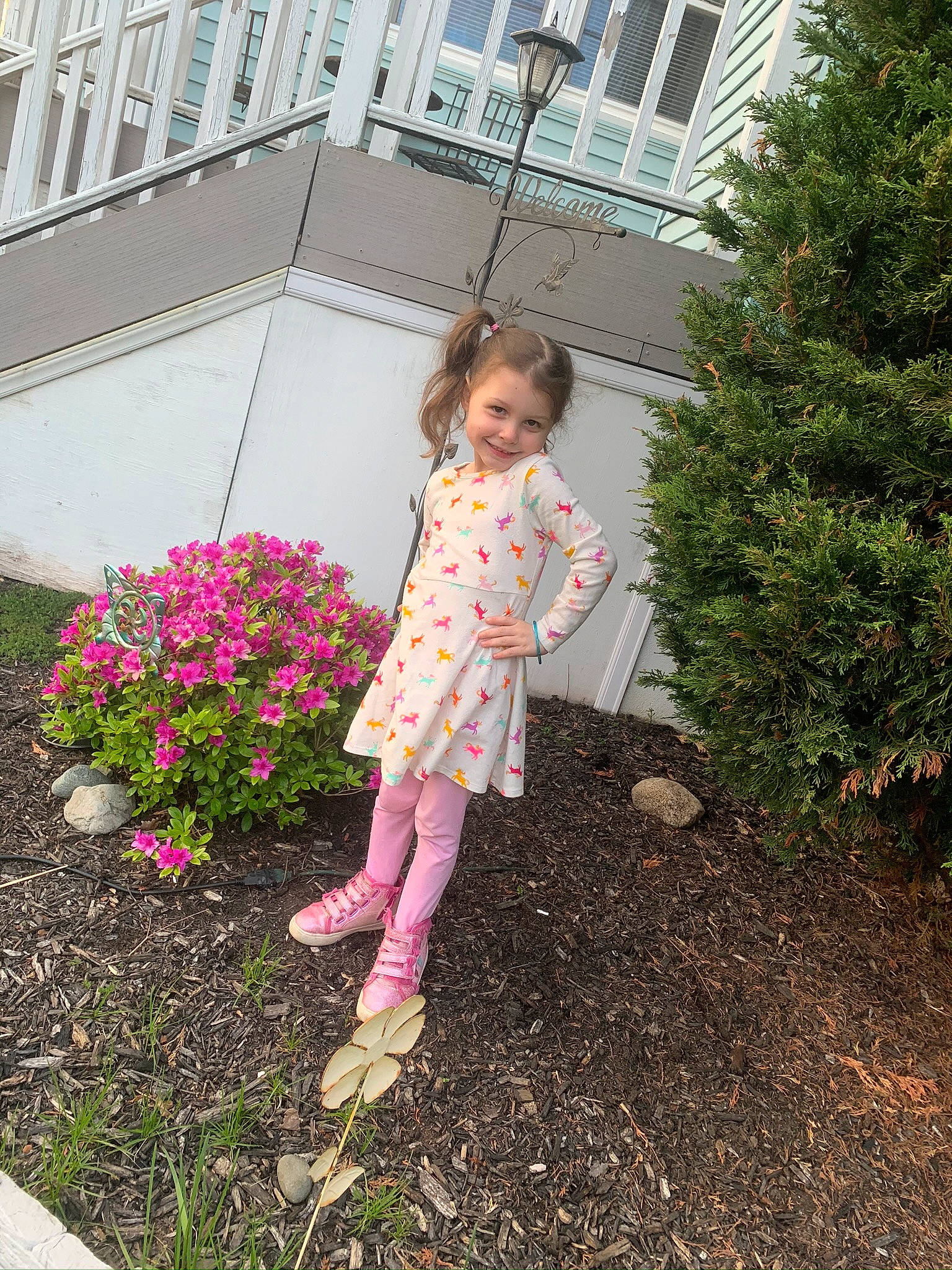 Haylee Grace is registered to the contest to win money with this photo: backyard, boot, child, dress, flower, footwear, garden, joy, leaf, leg, outerwear, pattern, person, pink, plant, shoe, shrub, spring, summer, textile