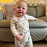 Eli-James joined the competition — help win amazing prizes! baby, blurry_background, cheeks, child, couch, eyes, face, hand, happy, indoor, living_room, one_child, overalls, pillow, portrait, smile, sofa, standing, striped_shirt, wood_floor
