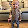 Eli-James joined the competition — help win amazing prizes! baby, carpet, child, cozy, cushion, hands, happy, hardwood_floor, indoor, living_room, pillow, plaid_pants, portrait, smile, socks, sofa, standing, sweater, teeth, toddler