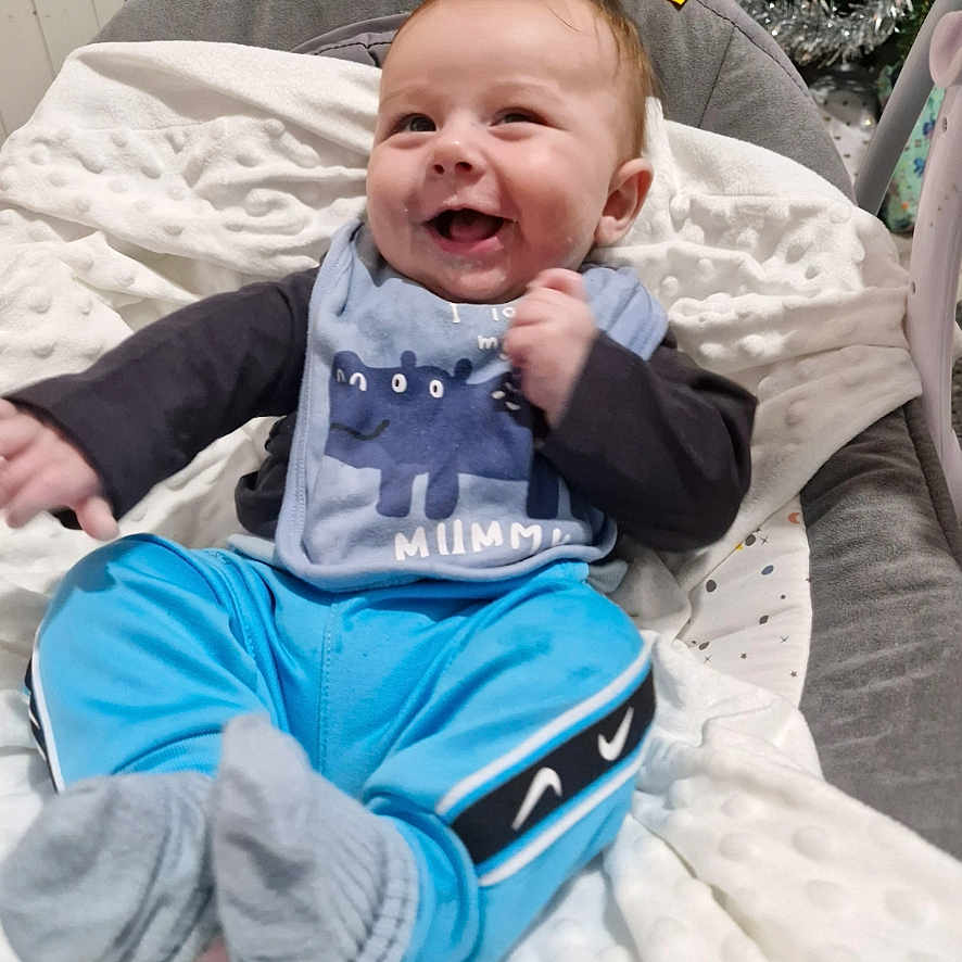 Kody joined the competition — help win amazing prizes! baby, babylaughing, clothing, cushion, face, furniture, happy, head, homedecor, hosiery, jeans, laughing, pants, person, photography, portrait, sitting, smile, sock, t_shirt
