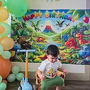 Ethan joined the competition — help win amazing prizes! balloons, birthday, celebration, child, clothing, colorful, dinosaur, face, flooring, green_pants, happy_birthday, indoor, party, poster, scooter, shoes, toddler, toy, wall_decor, white_shirt