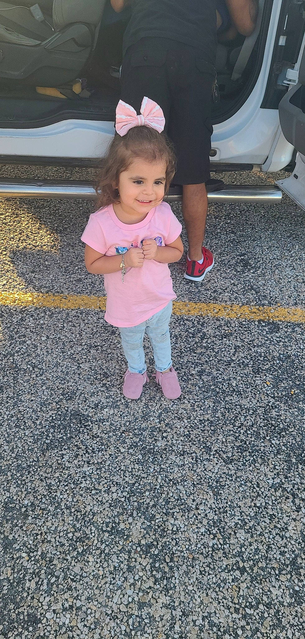 Maleah is registered to the contest to win money with this photo: asphalt, baby_toddler_clothing, child, flooring, foot, fun, gesture, grass, human_leg, joy, leg, mammal, people, person, road_surface, shoe, sidewalk, smile, sneakers, toddler