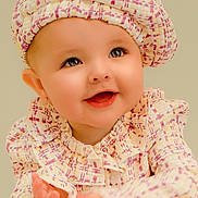 Charlotte is registered to the contest to win money with this photo: baby, child, infant, smiling, happy, clapping, portrait, close_up, face, eyes, hat, outfit, pink, cream, patterned_clothing, indoors, studio, looking_at_camera, joyful, photography
