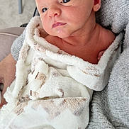 Donovan joined the competition — help win amazing prizes! baby, newborn, blanket, soft, wrapped, face, skin, person, infant, cozy, knitwear, warm, indoor, closeup, child, cute, resting, expression, human, comfort