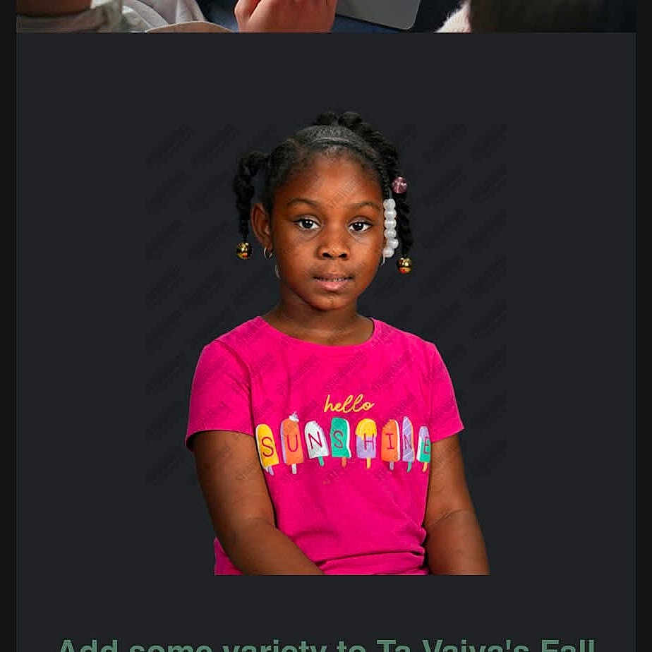 Ta Vaiya is registered to the contest to win money with this photo: african_american, beads, braids, calm_expression, casual_clothing, child, colorful, cute, fashion, girl, headshot, indoors, person, pink_shirt, portrait, smiling, studio_background, text_on_clothing, tshirt, young