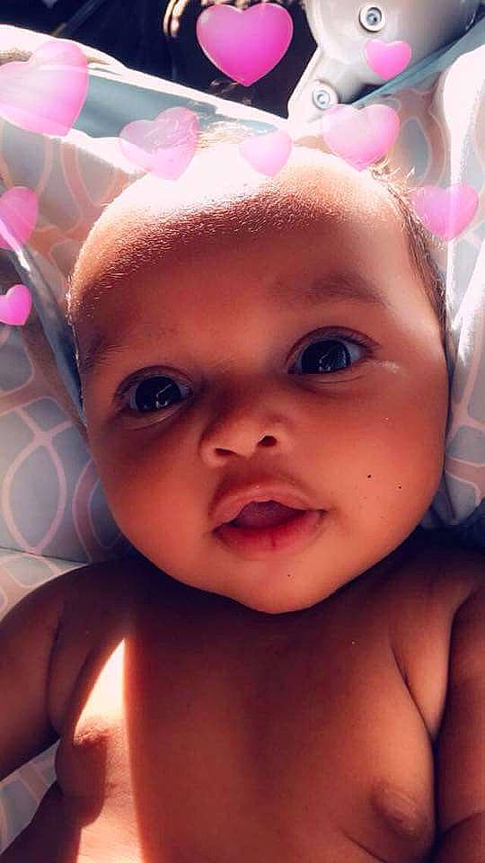 Zoey is registered to the contest to win money with this photo: black_hair, cheek, child, chin, ear, eye, eyebrow, eyelash, face, forehead, girl, head, infant, lip, mouth, nose, person, pink, skin, smile