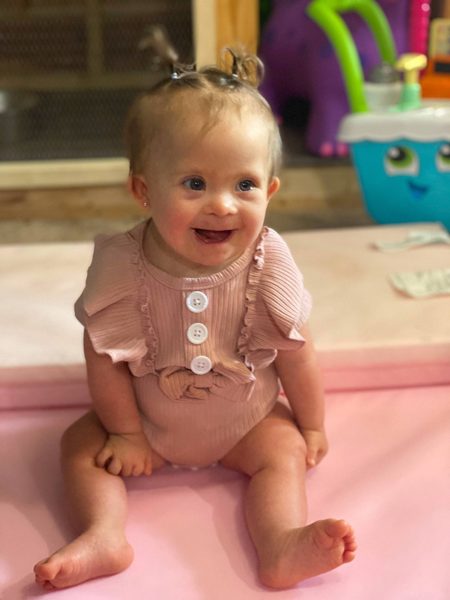 Bristol is registered to the contest to win money with this photo: baby, baby_toddler_clothing, cheek, child, chin, eye, face, floor, flooring, foot, happy, head, human_body, iris, joy, mouth, nose, person, pink, skin
