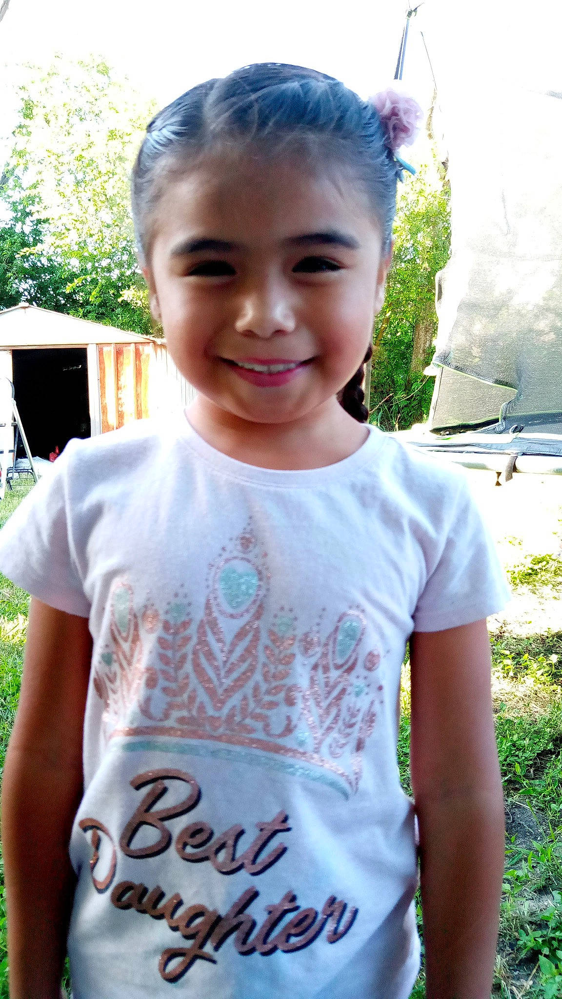 Aliyanna is registered to the contest to win money with this photo: active_shirt, child, chin, face, forehead, fun, grass, hair, hairstyle, happy, head, joy, leisure, neck, person, plant, recreation, sleeve, smile, t_shirt