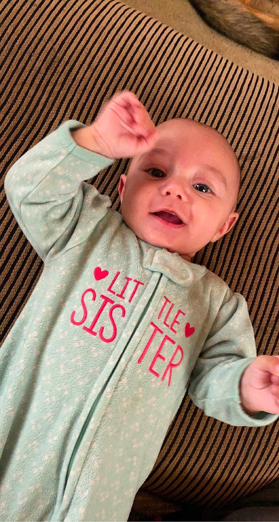 Elena is registered to the contest to win money with this photo: baby, baby_safety, baby_toddler_clothing, cheek, chin, collar, comfort, eyebrow, happy, infant_bed, iris, nose, outerwear, person, pink, skin, sleeve, smile, t_shirt, textile