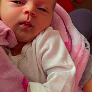 Cali Maye is registered to the contest to win money with this photo: baby, newborn, blanket, pink, clothing, face, infant, portrait, cute, sleepy, soft, hand, indoors, cozy, warm, child, person, closeup, babyclothes, resting