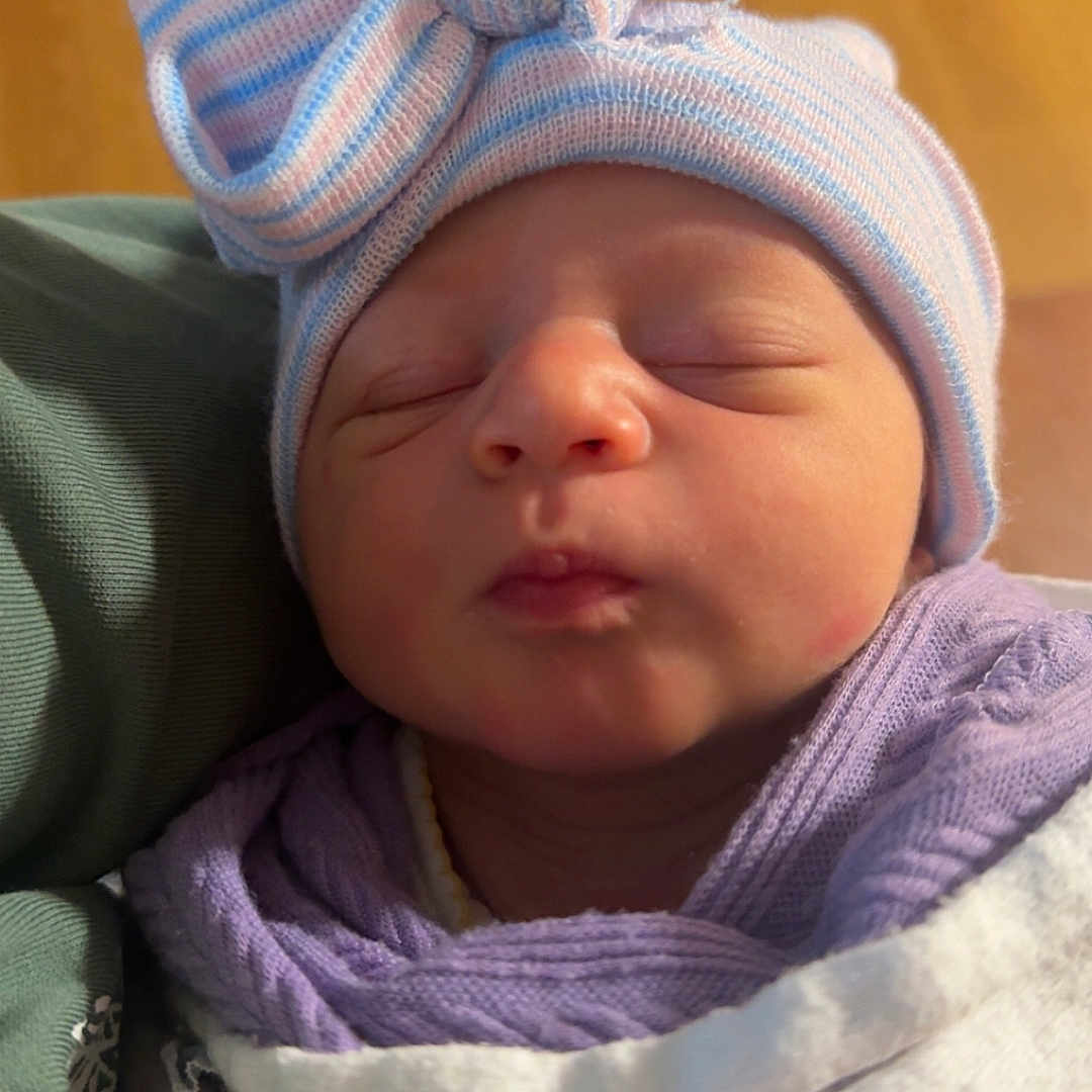 Cali Maye is registered to the contest to win money with this photo: baby, blanket, bow, child, closed_eyes, clothing, cozy, cute, face, hat, headwear, indoors, infant, newborn, peaceful, portrait, sleeping, soft_light, striped_hat, wrapped