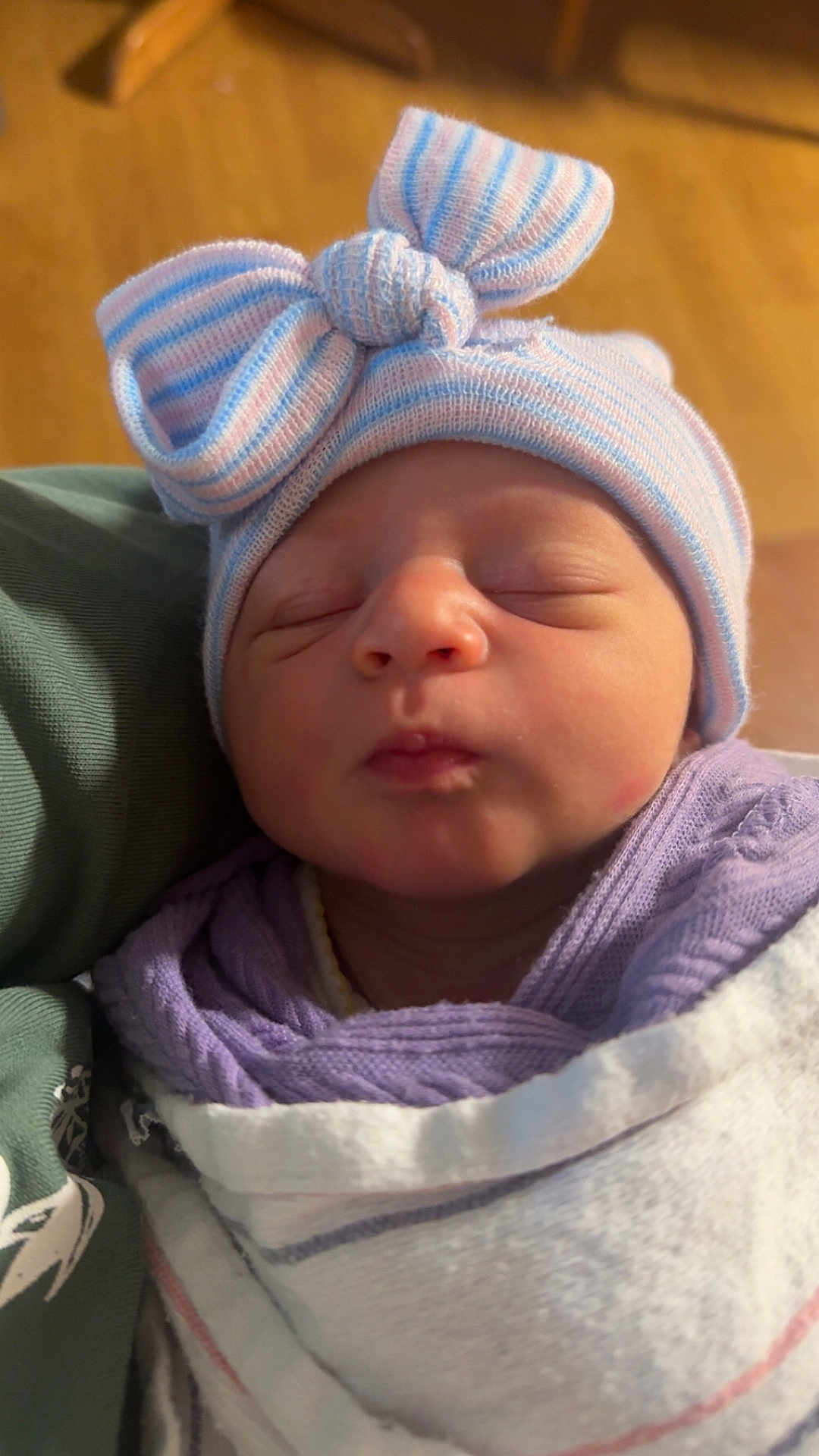 Cali Maye is registered to the contest to win money with this photo: newborn, baby, sleeping, hat, bow, striped_hat, blanket, wrapped, cozy, infant, face, closed_eyes, soft_light, cute, peaceful, indoors, portrait, child, headwear, clothing
