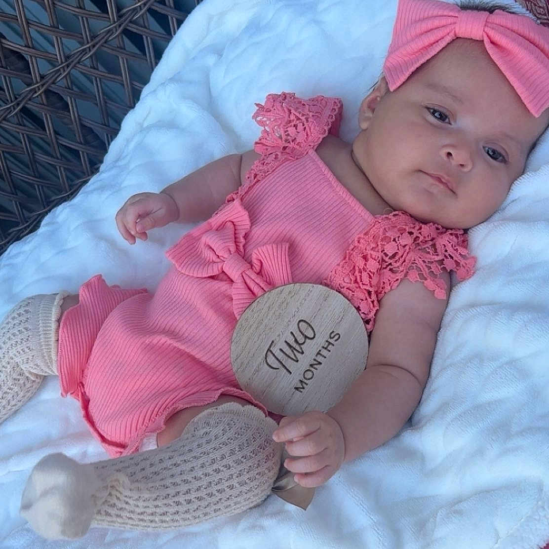 Janely joined the competition — help win amazing prizes! adorable, baby, blanket, child, closeup, cute, headband, indoors, infant, knitted_socks, milestone, person, pink_outfit, portrait, resting, sleepy, soft_lighting, two_months, wicker, wooden_sign