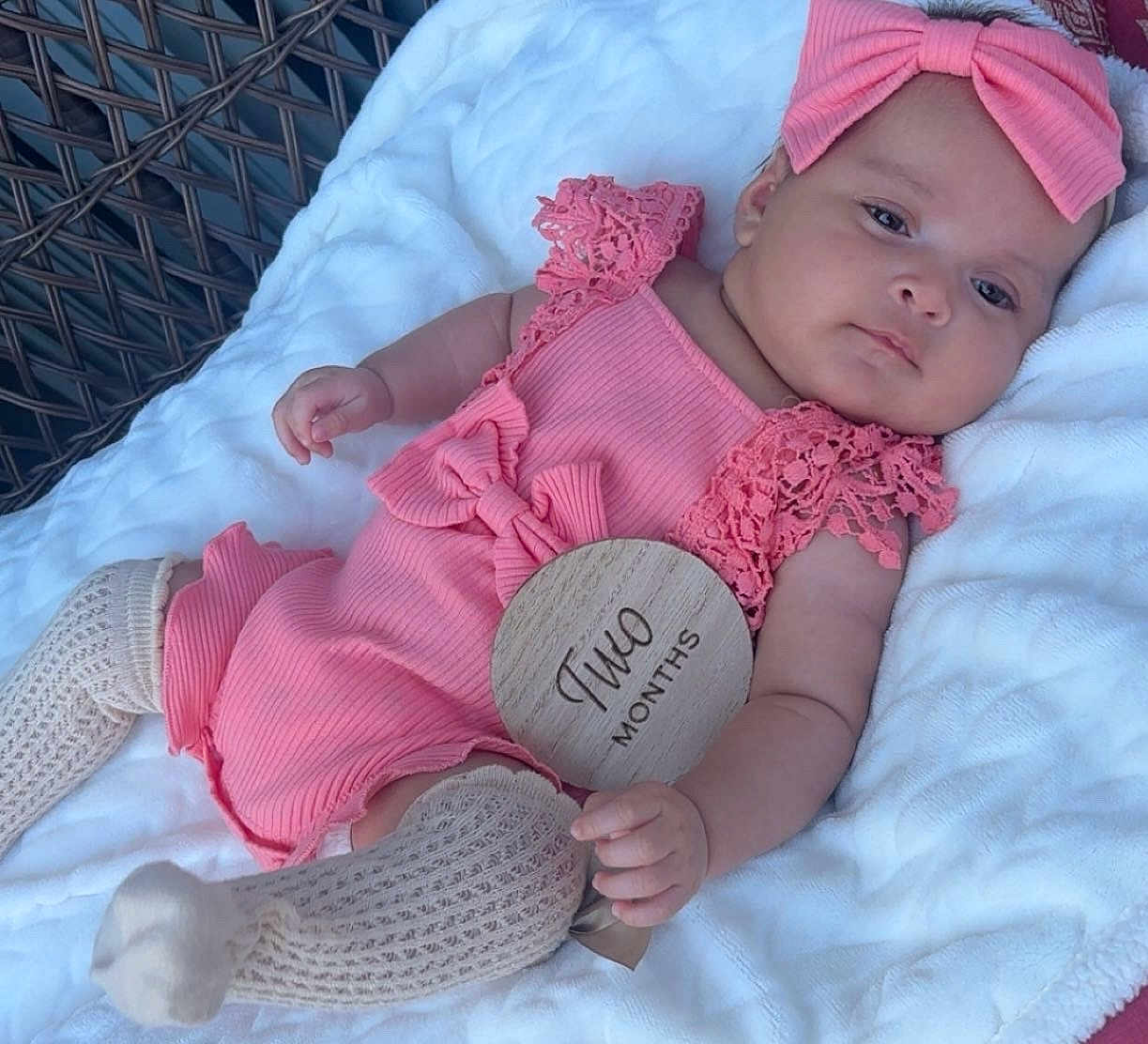 Janely joined the competition — help win amazing prizes! baby, infant, pink_outfit, headband, wooden_sign, two_months, blanket, knitted_socks, wicker, resting, cute, milestone, portrait, indoors, soft_lighting, child, adorable, closeup, person, sleepy
