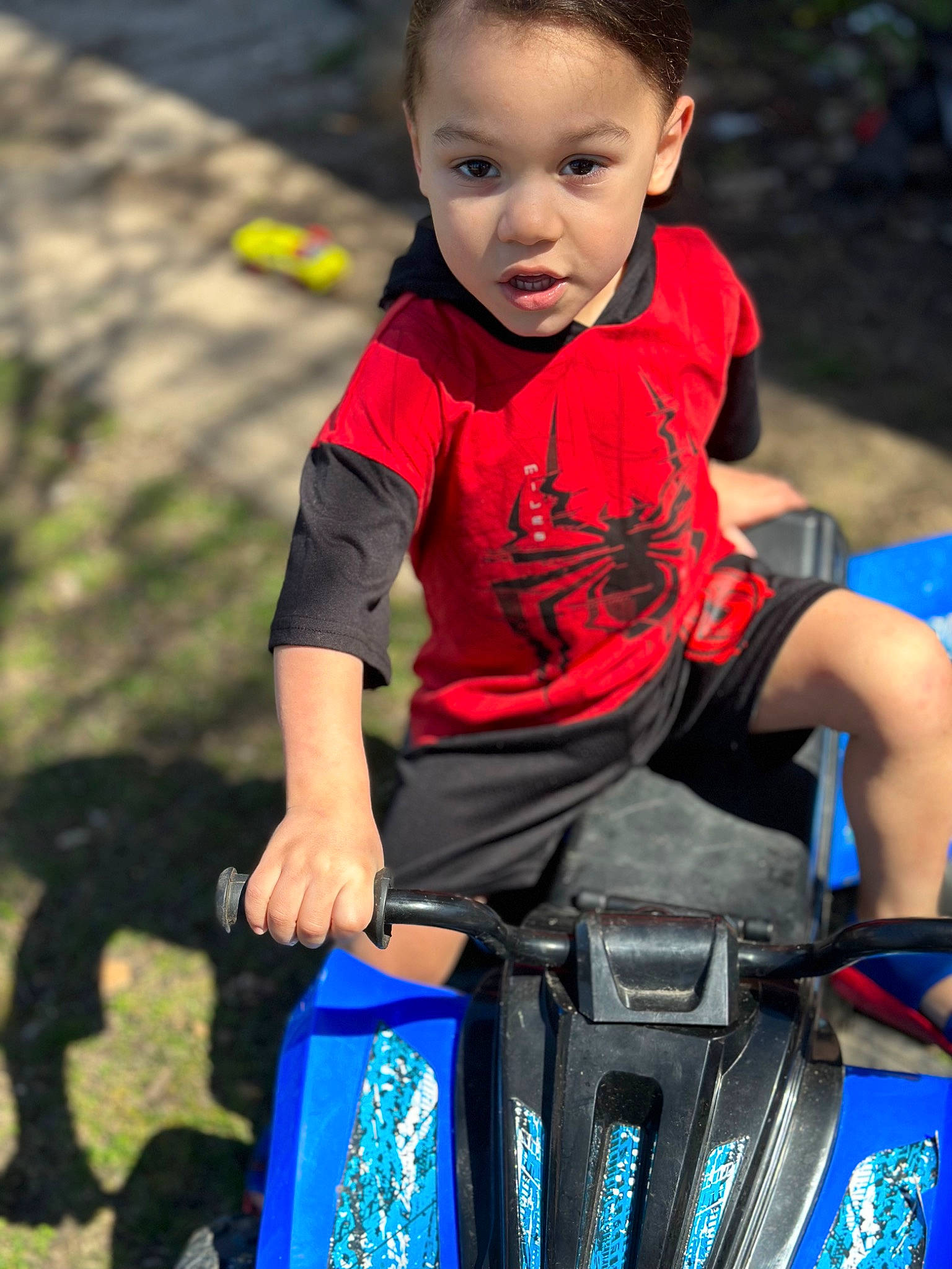 Kamarion joined the competition — help win amazing prizes! arm, baby, blue, chair, child, electric_blue, fun, grass, hairstyle, happy, leisure, person, personal_protective_equipment, play, recreation, shorts, sitting, standing, t_shirt, toddler
