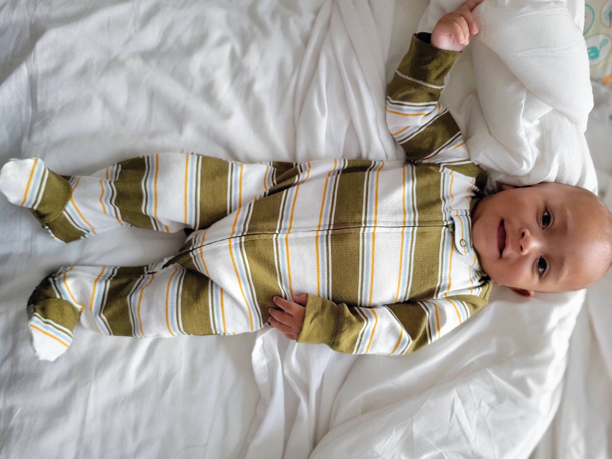 Jalen joined the competition — help win amazing prizes! baby, baby_toddler_clothing, child, comfort, couch, dress, gesture, hand, happy, human_leg, leg, linens, pattern, person, plaid, room, sleeve, smile, tartan, textile